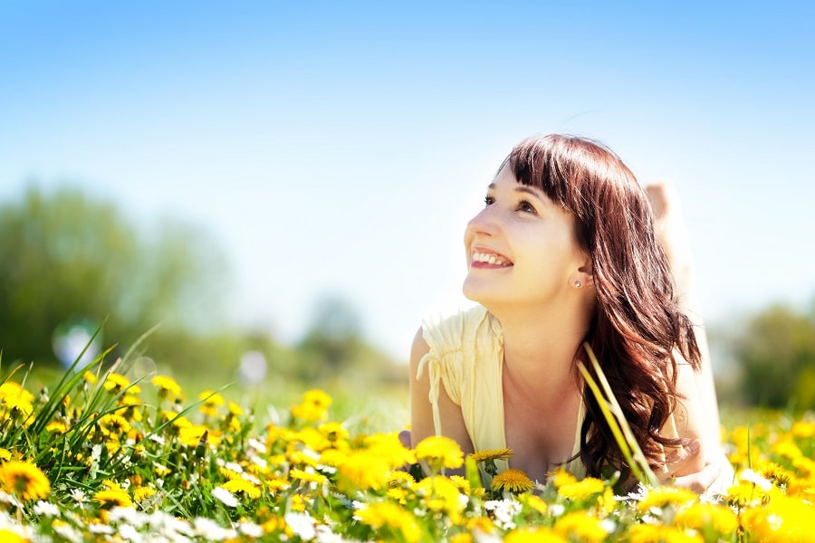 Woman laying in field of flowers