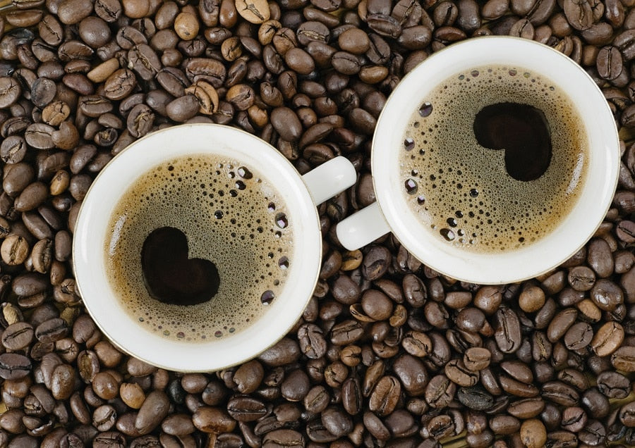 Two cups of coffee with hearts in the foam