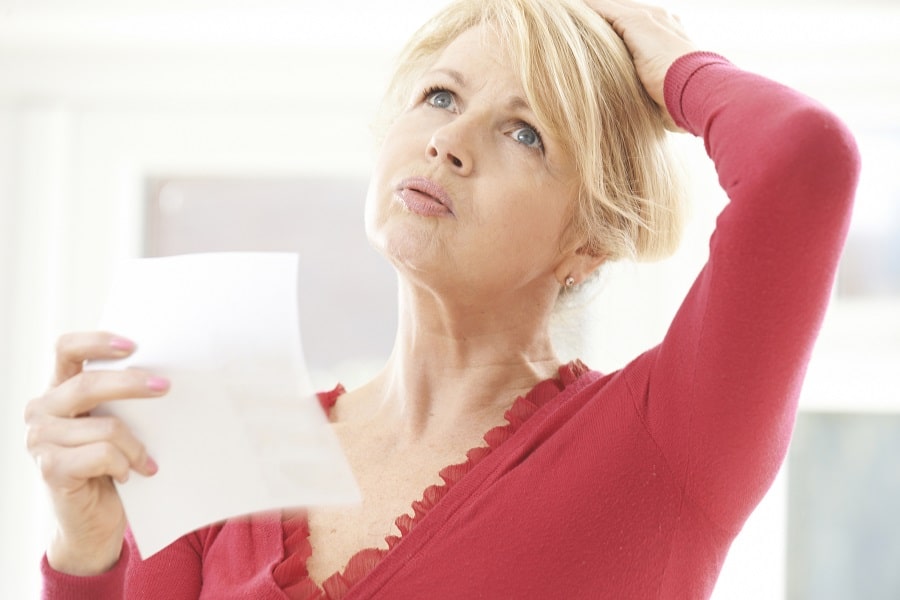 A woman holding a piece of paper
