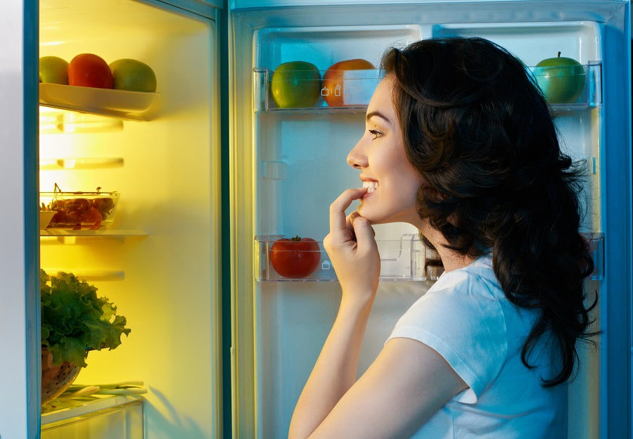 Woman looking into fridge