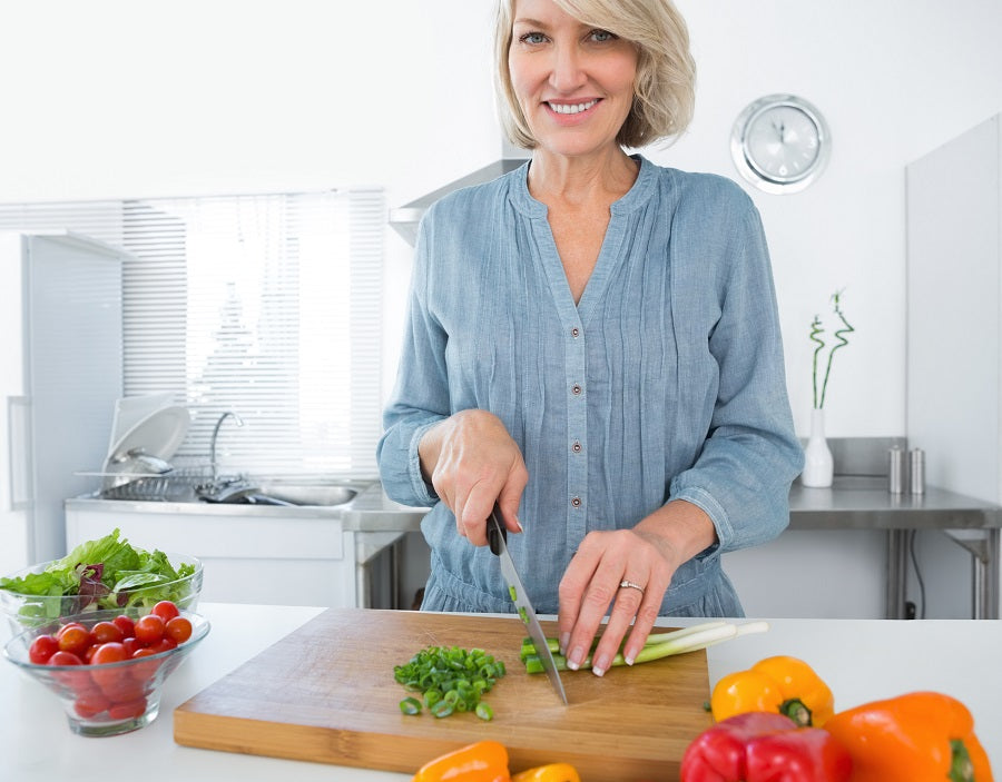 Woman chopping vegetables in the kitchen