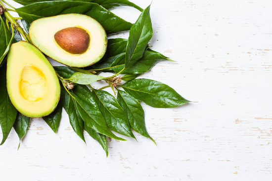 Avocado sliced in half against a white background