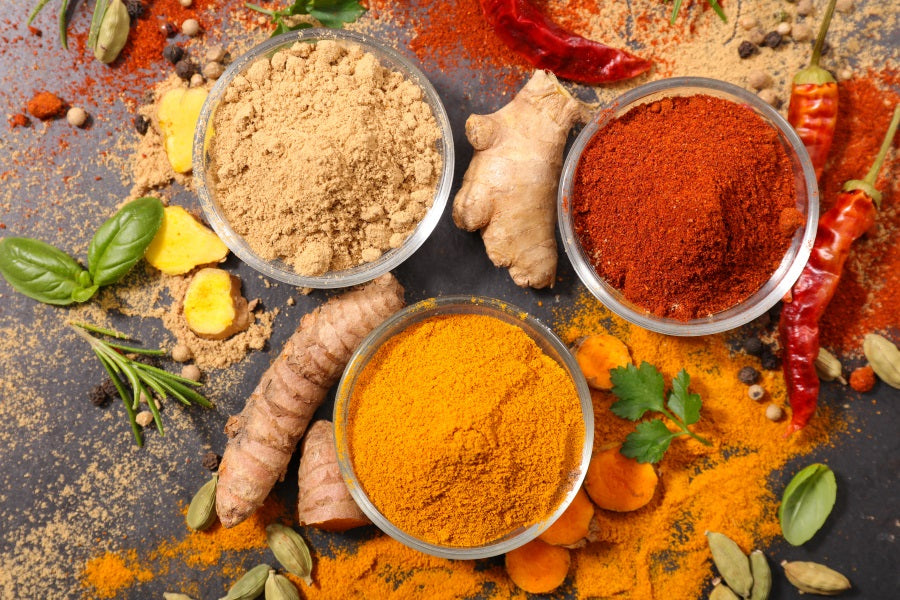 Three bowls of colorful spices