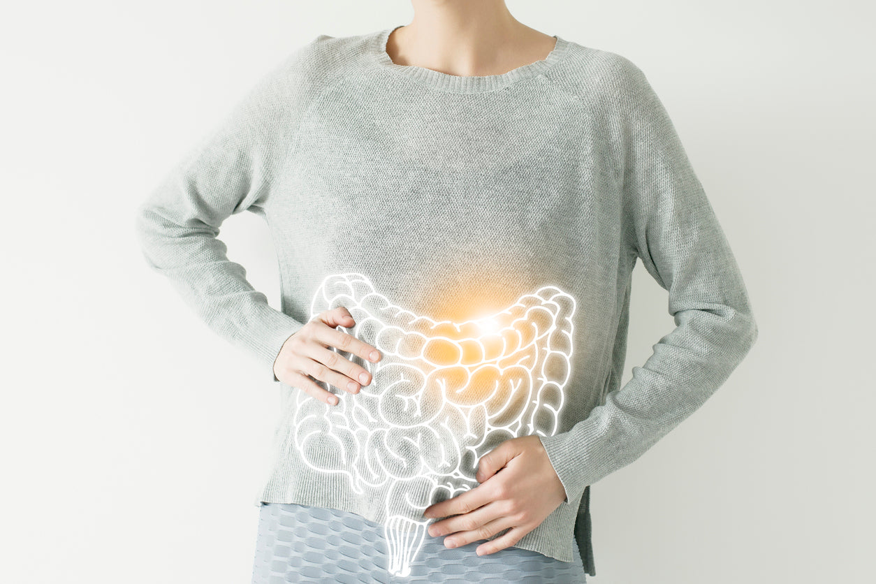 Women with hand on her stomach to show bad bacteria leaving the gut