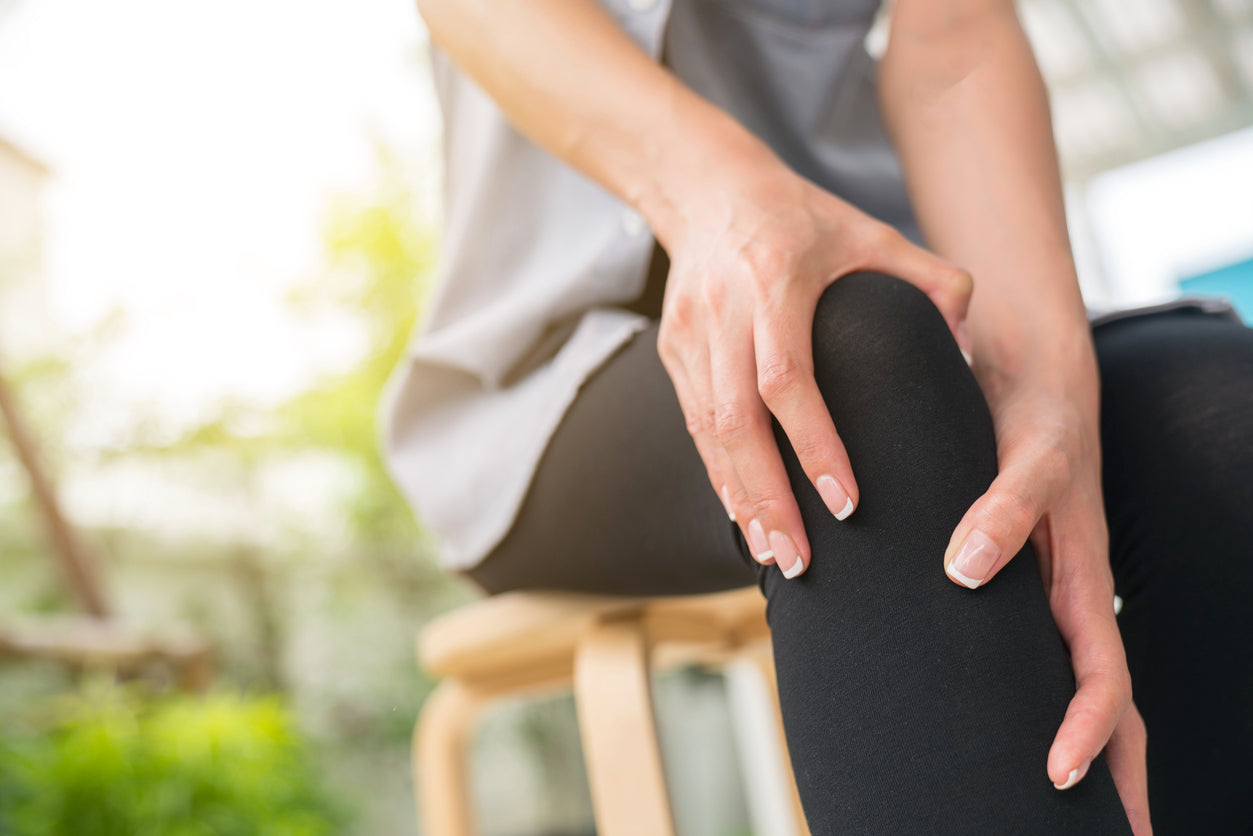 Woman holding her knee