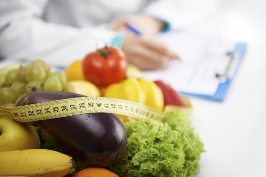A doctor writing on foods that help with a hormone imbalance