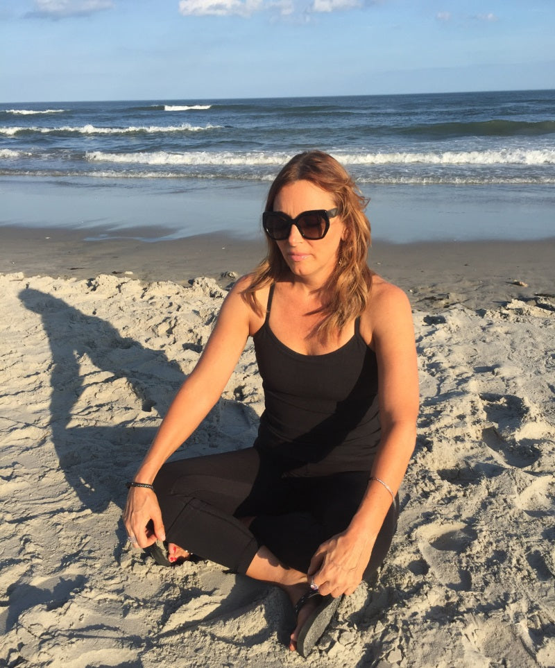 Woman meditating on the beach