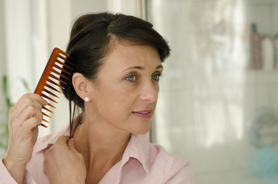 Woman combing her hair