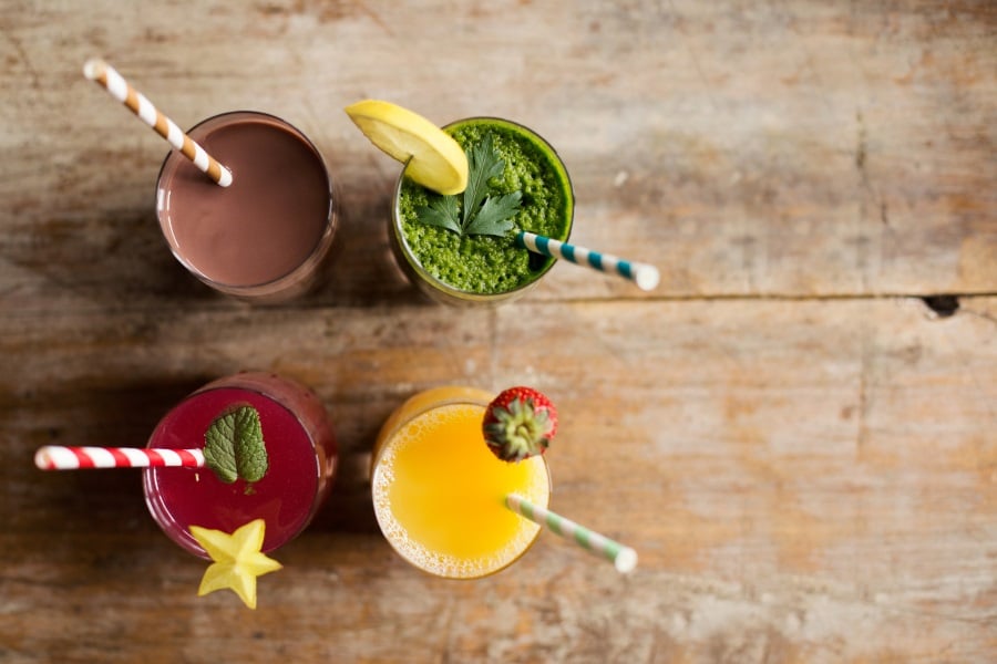 Four smoothies with straws