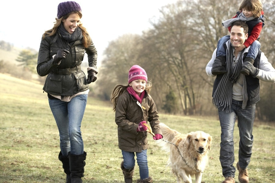 Family with dog playing outside