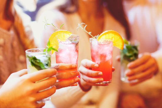 Four women clinking their glasses