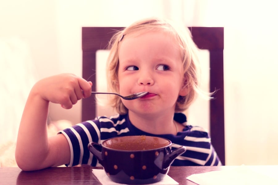Child eating bone broth