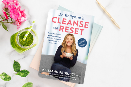 Dr. Kellyann's Cleanse and Reset book on marble with greenery