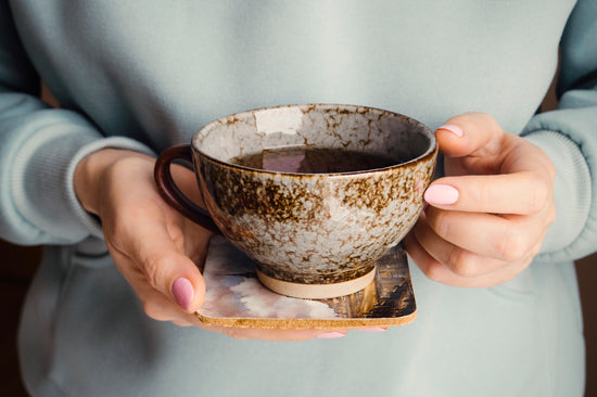 A woman holding a cup of coffee