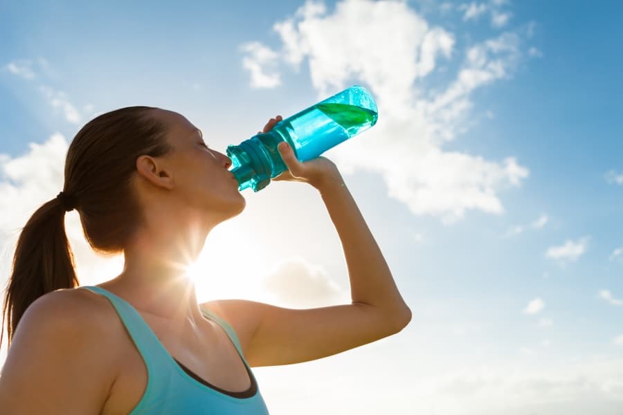 Woman drinking water out of a bottle