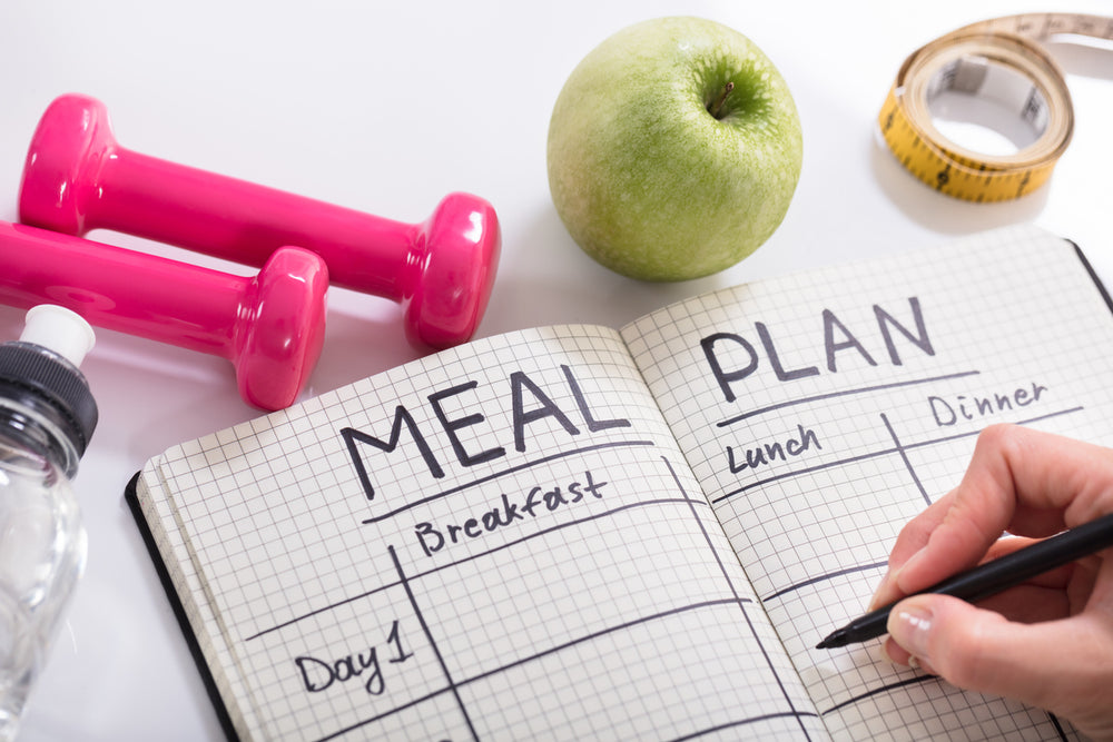 meal plan with weights, apple, and measuring tape