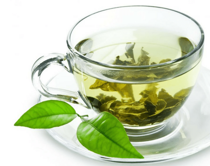 A glass mug of green tea