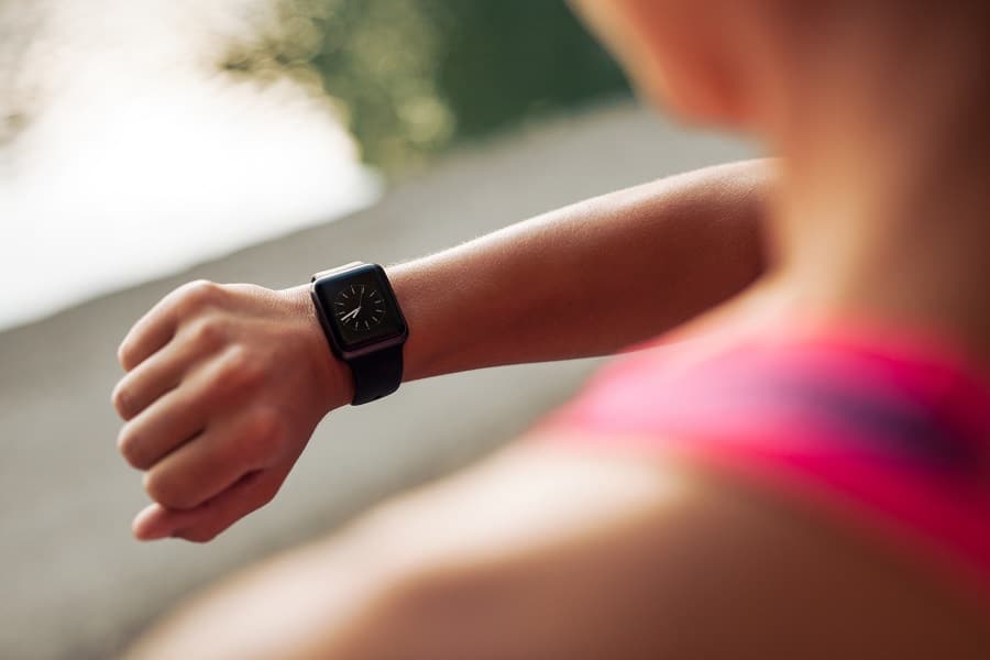 A woman checking her smart watch during cardio