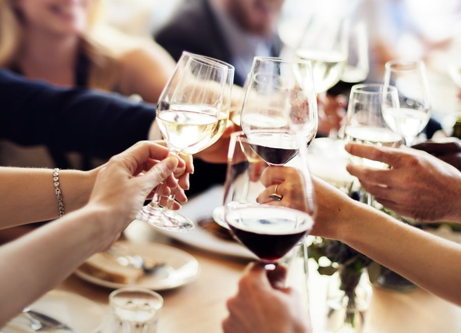 A group saying cheers with wine