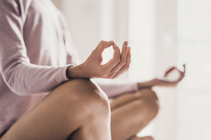 woman doing yoga and meditating