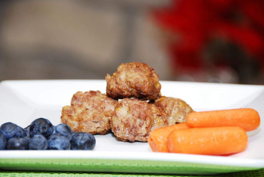 Meatballs on a plate with carrots and blueberries