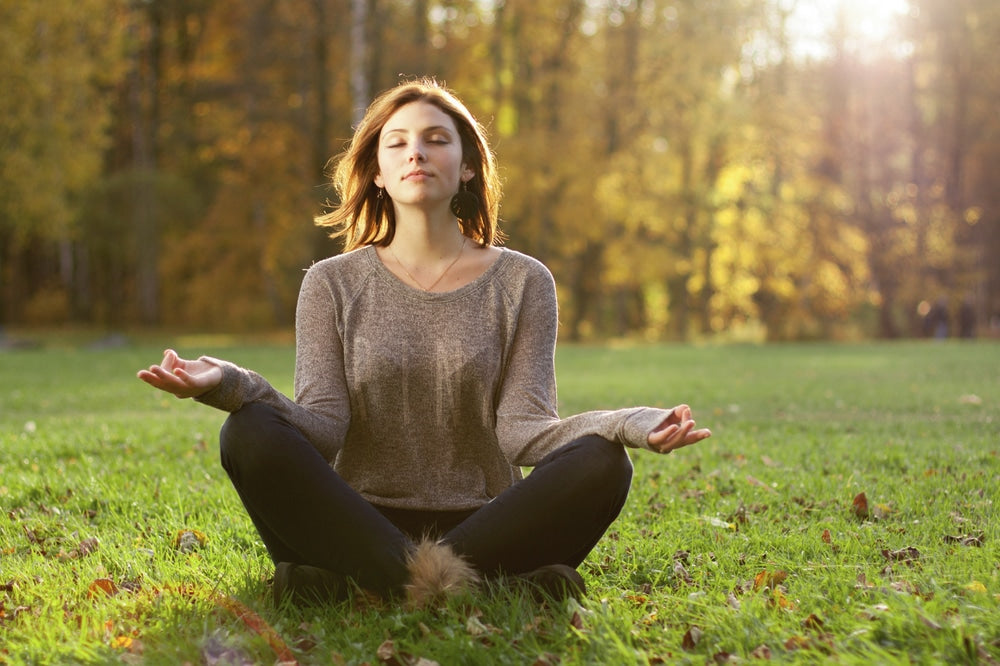Woman meditating outside
