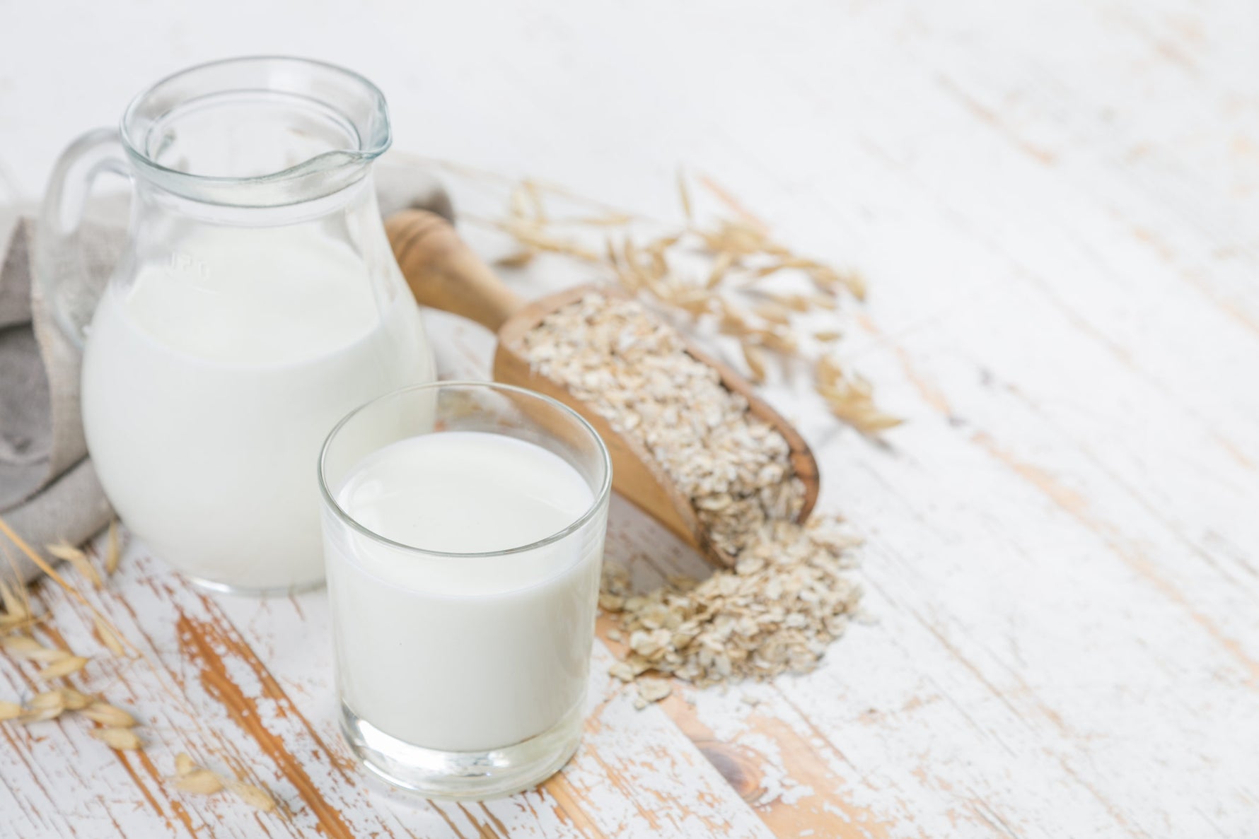 Oat milk in a pitcher and a glass 