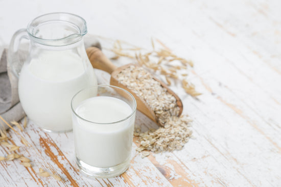Oat milk in a pitcher and a glass 