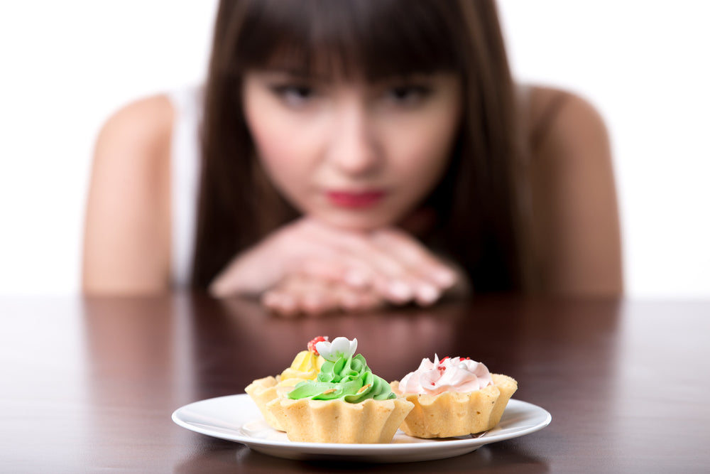 Woman staring at a plate of appetizers
