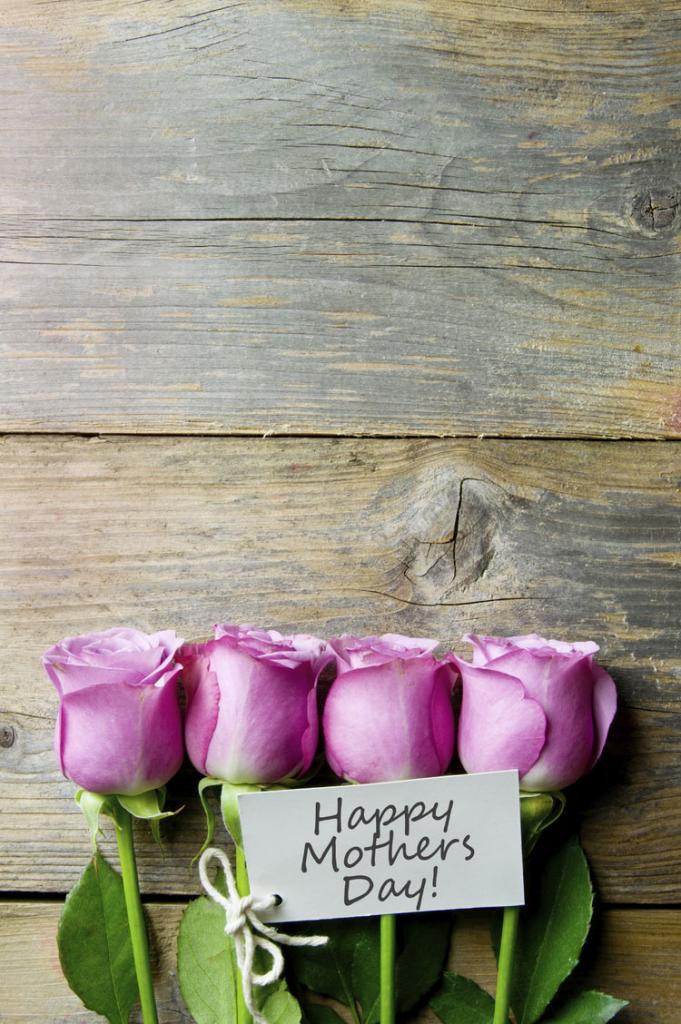Four roses with a card saying Happy Mothers Day