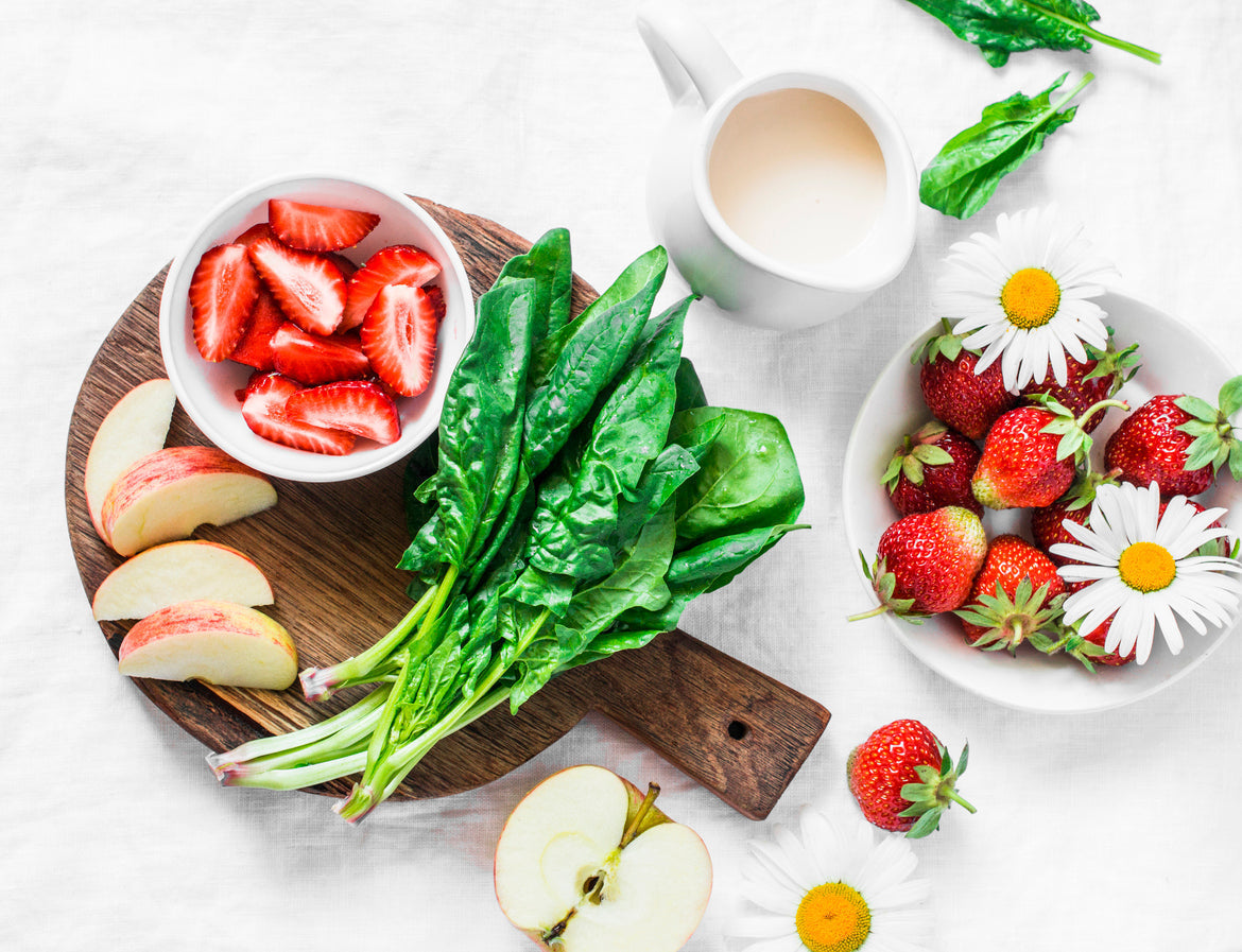 fruits and vegetables laid out on table for a smoothie cleanse