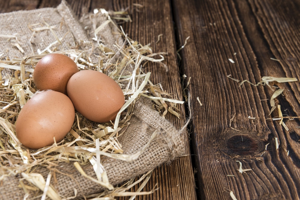 3 eggs on burlap and wood