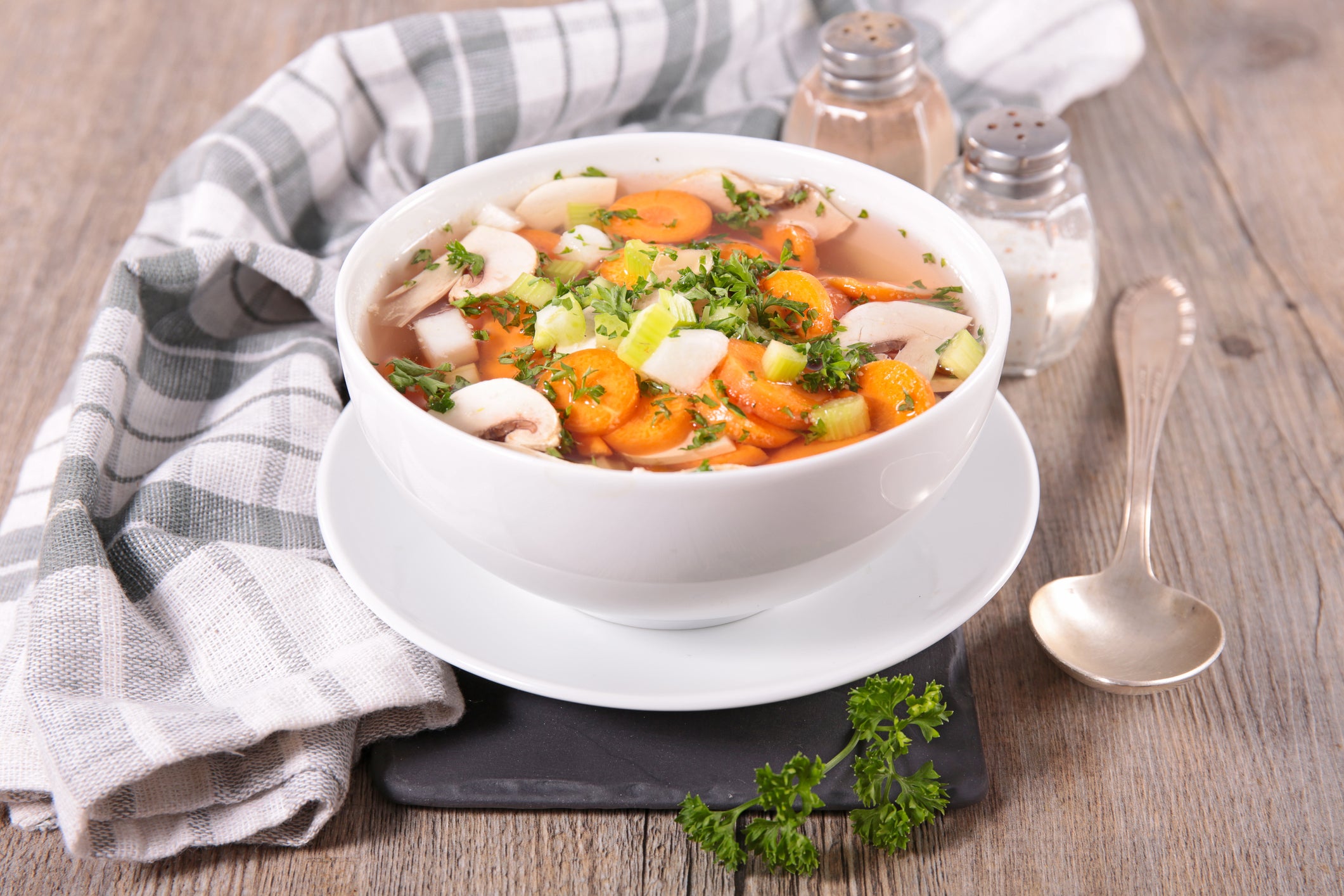 Bowl of soup with towel and spoon