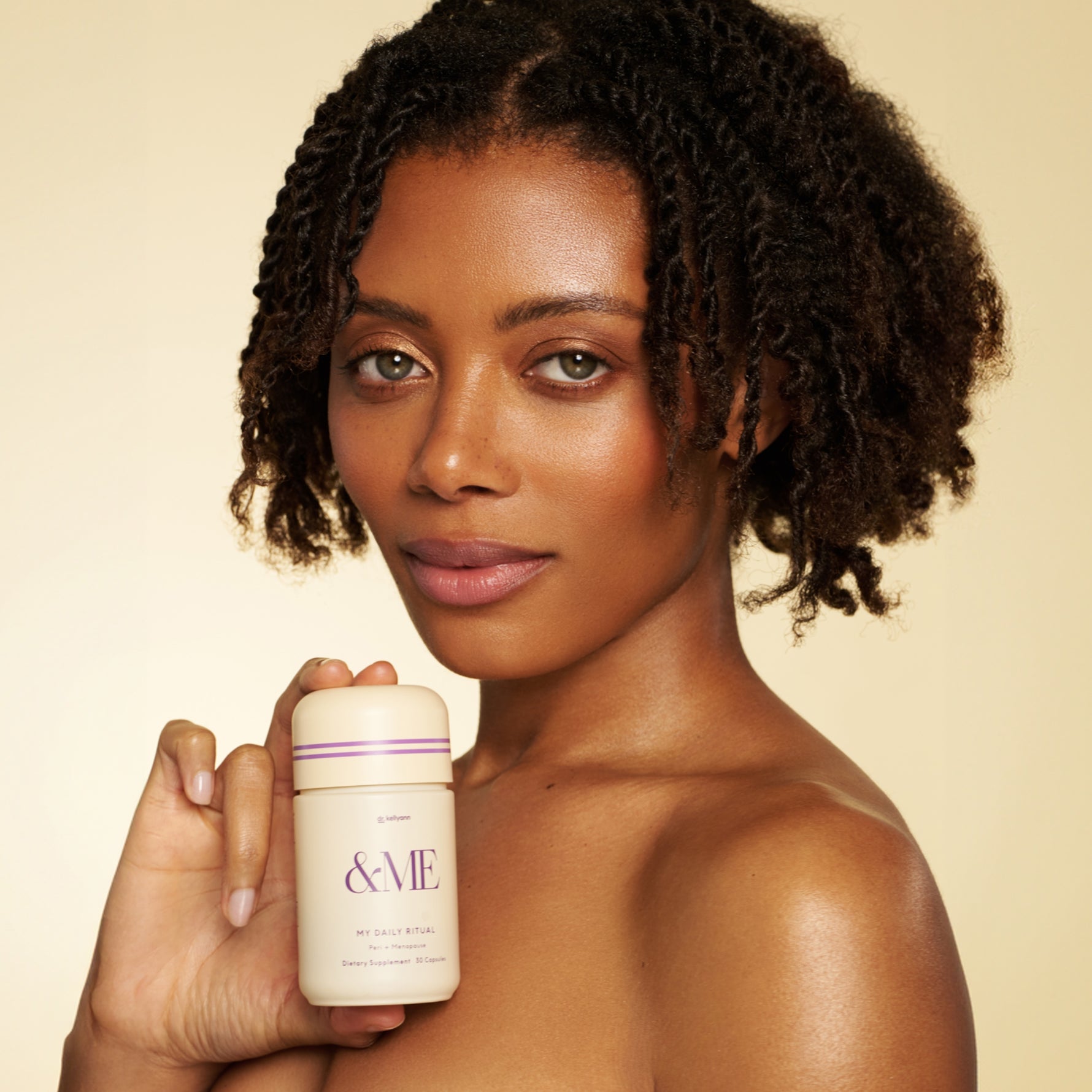 Dr. Kellyann &ME Peri + Menopause and model holding the item 