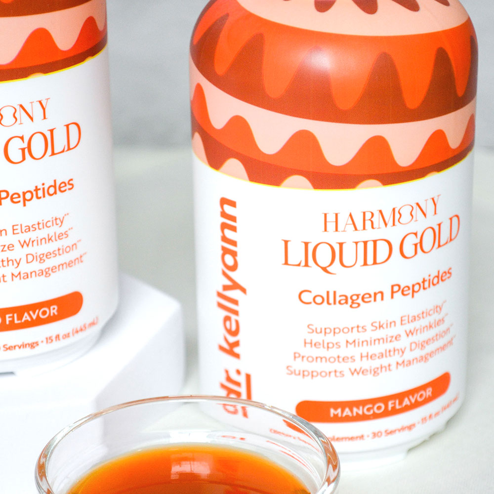 Two bottles of Dr. Kellyann Harmony Liquid Gold Collagen Peptides with a small glass containing the product.