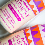 Two bottles of Dr. Kellyann Harmony Liquid Daily Multivitamin with colorful labels on a white background.